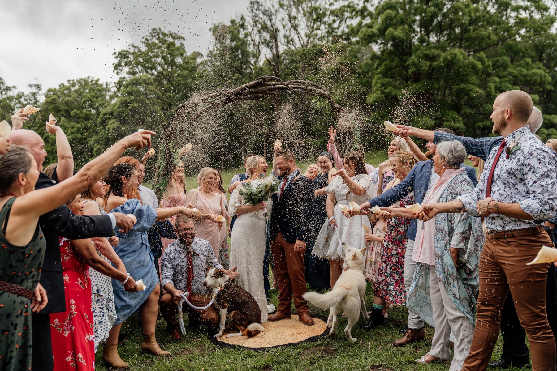 Wedding guests throwing dried lavender at bride and groom at Gold Farm House wedding