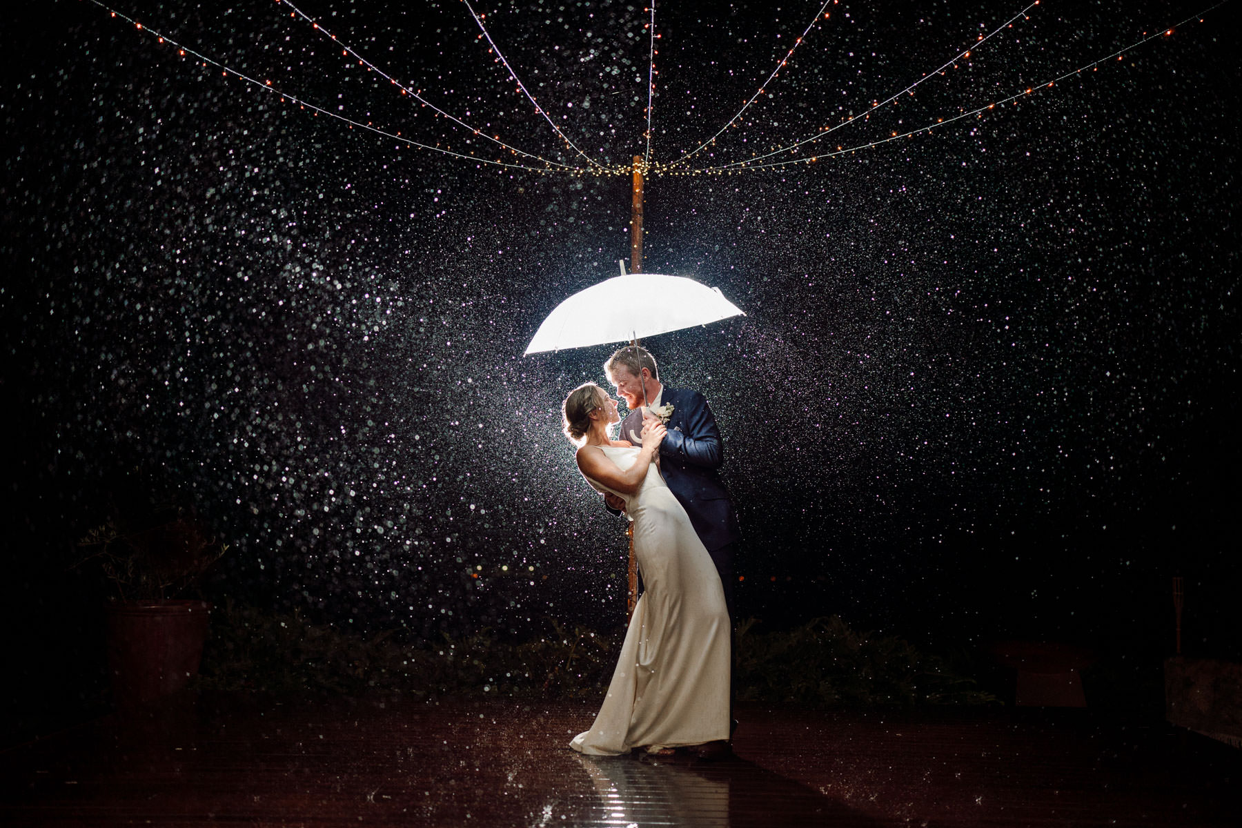Rain photo with bride and groom at Byron Bay