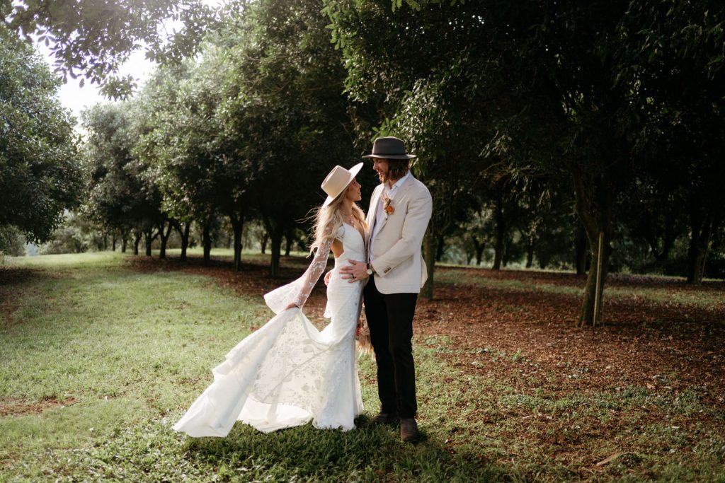 Bride and Groom under macadamia orchards at Byron Bay wedding venue The Orchard Estate