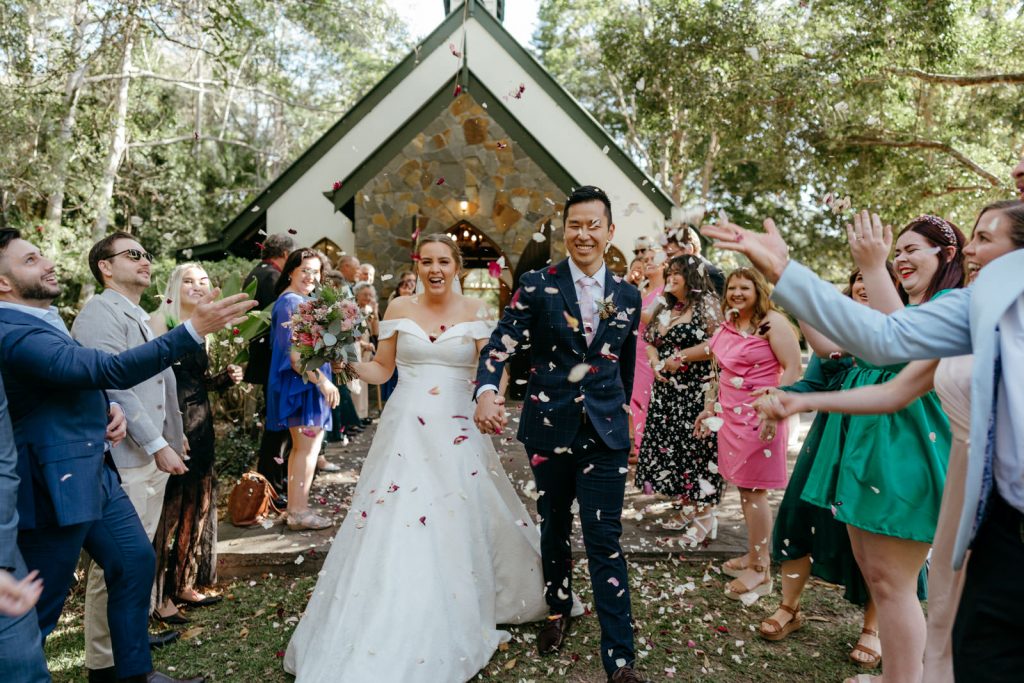 Bride and groom confetti ceremony exit outside Gold Coast wedding venue Coolibah Downs