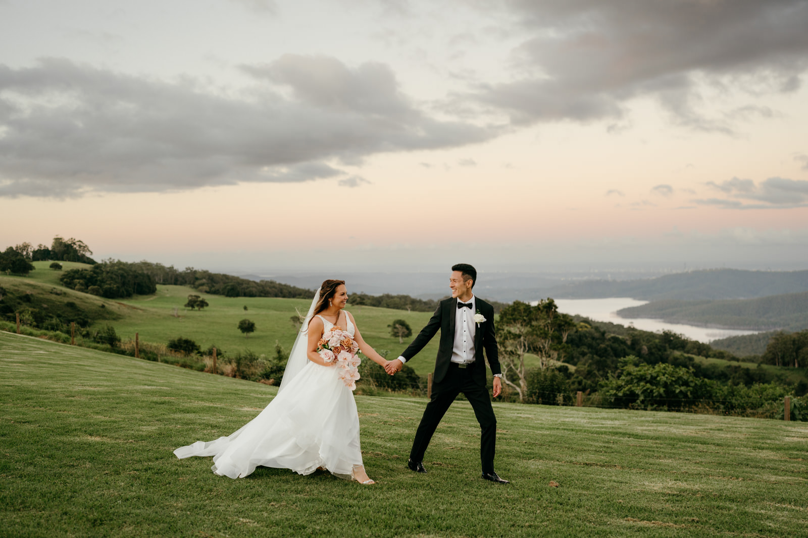 Bride and groom walking with valley views at Rosewood Estate 1\\