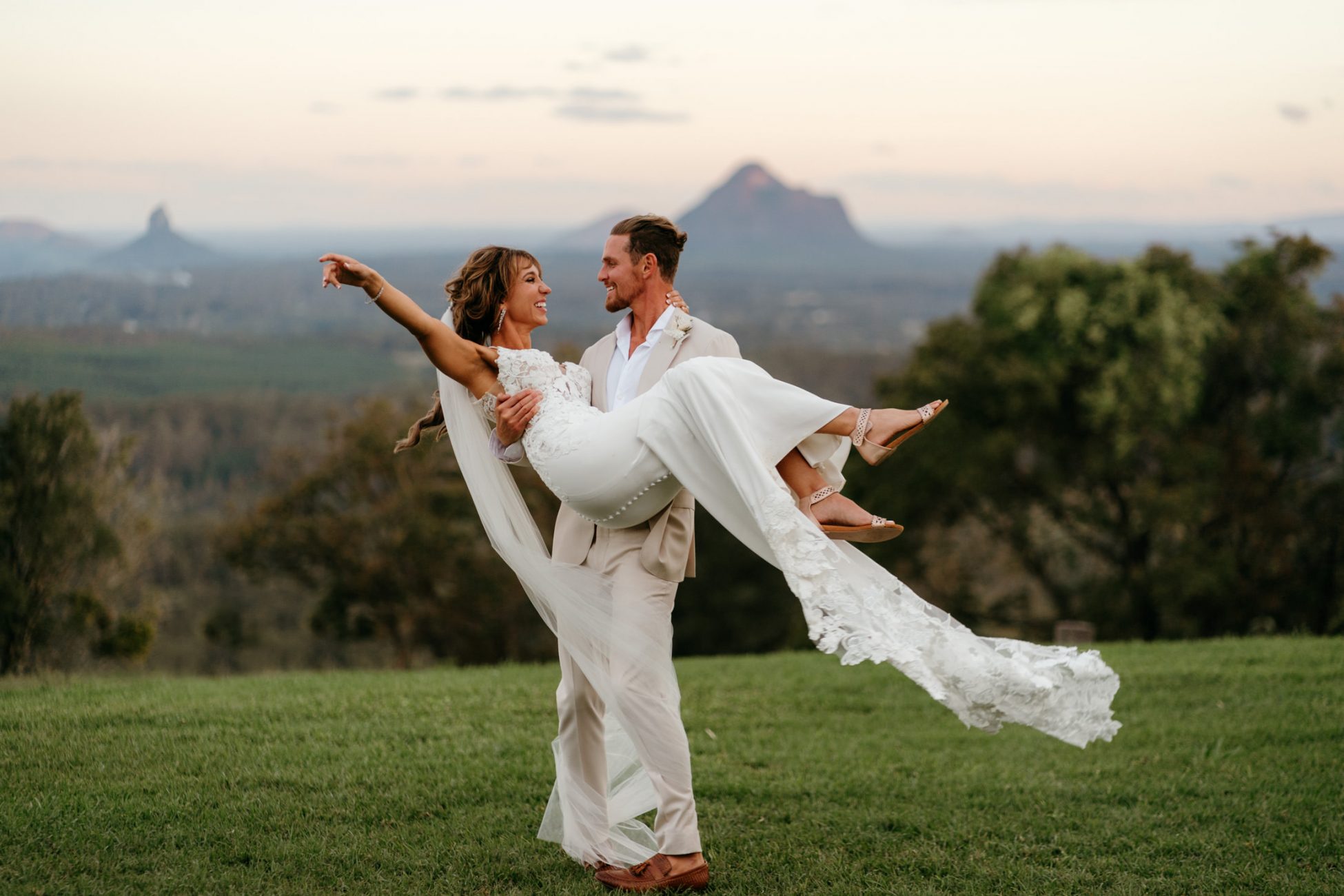 Newlyweds dancing with mountain backdrop by Byron Bay wedding photographer Sam Wyper
