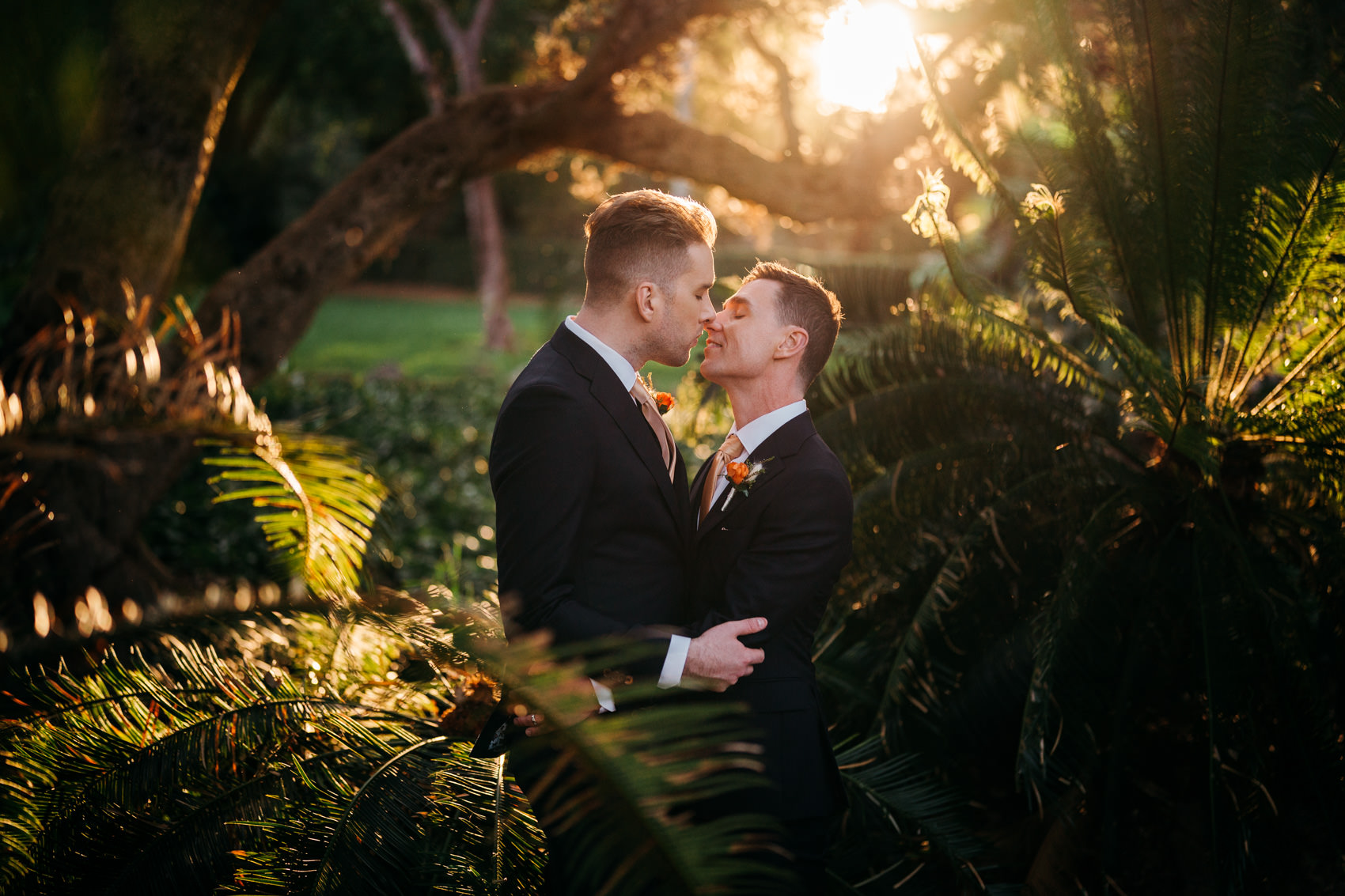 Same sex couple kissing during golden hour